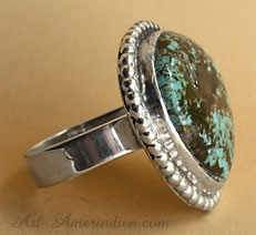 A beautiful Turquoise with brown matrix is serrated on this South Western ring made in USA and signed by American Artist